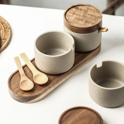 Ceramic and wooden kitchenware set on a white surface