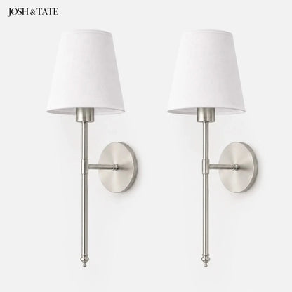 Josh & Tate - Cordless Fabric Wall Light - Pair of wall sconces with white lampshades and metallic finish on a white background, featuring the brand 'Josh & Tate'.