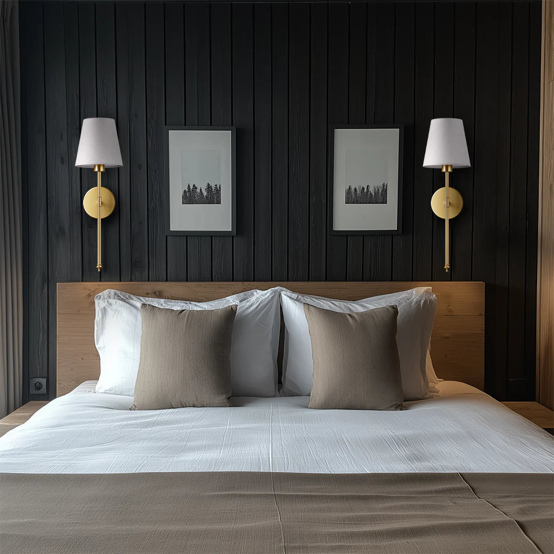 Modern bedroom with wooden headboard, gray bedding, and wall lamps.