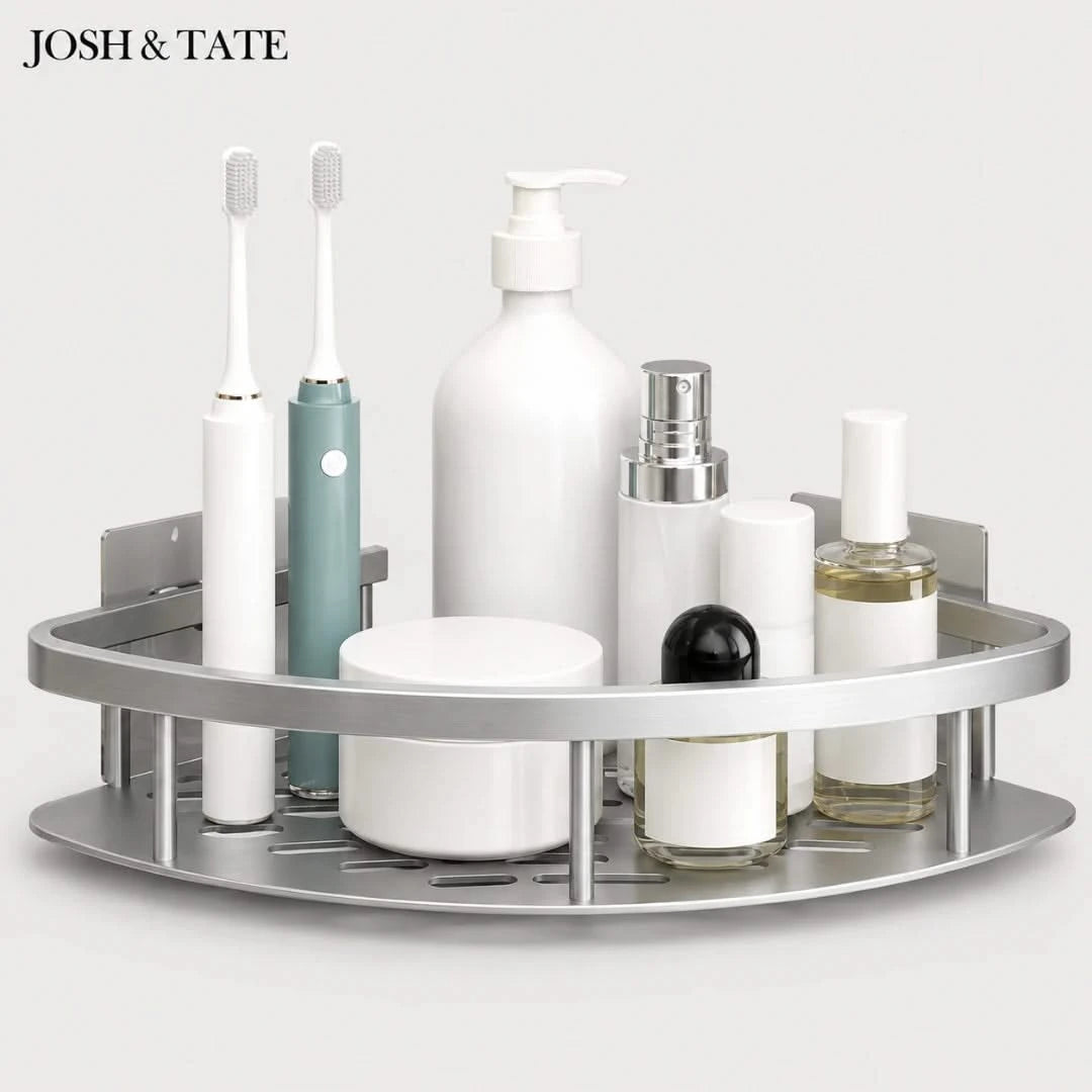 Josh & Tate - CornerLock™ Adhesive Shower Shelf - Bathroom corner shelf with various toiletries including bottles and a toothbrush on a white background.