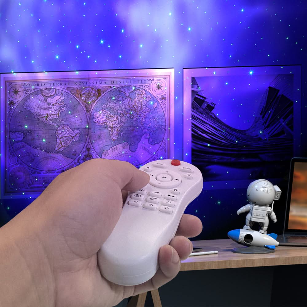 Hand holding a remote control with a starry night sky and world map projection in the background.