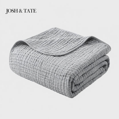 Josh & Tate - CottonFold™ Thick Air Conditioner Blanket - Folded gray quilt with 'Josh & Tate' branding on a white background