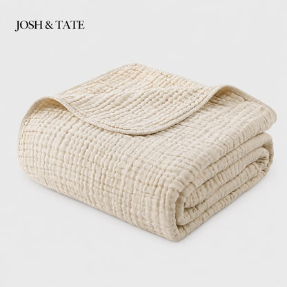 Josh & Tate - CottonFold™ Thick Air Conditioner Blanket - Folded beige quilt with 'Josh & Tate' branding on a light gray background