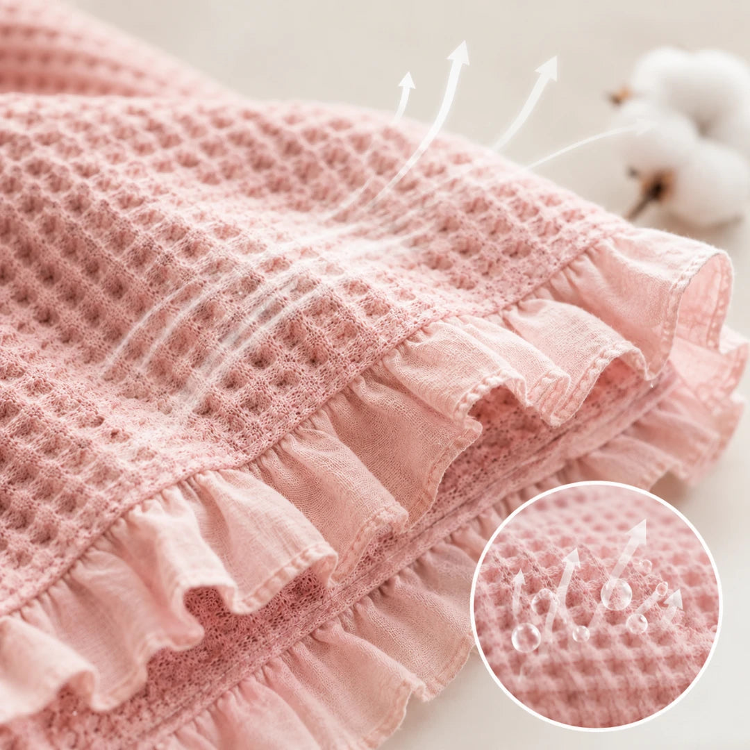 Josh & Tate - CozyCradle™ Ruffle-Edge Cotton Bed Blanket - Pink textured fabric with ruffled edge and 'dodo' branding.