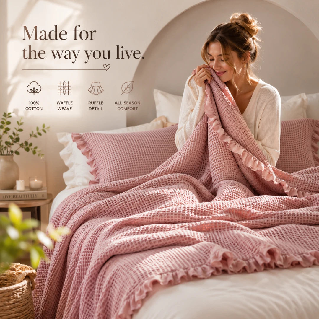 Josh & Tate - CozyCradle™ Ruffle-Edge Cotton Bed Blanket - Woman wrapped in a pink blanket on a bed with text about product features.