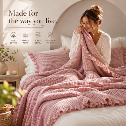 Josh & Tate - CozyCradle™ Ruffle-Edge Cotton Bed Blanket - Woman wrapped in a pink blanket on a bed with text about product features.
