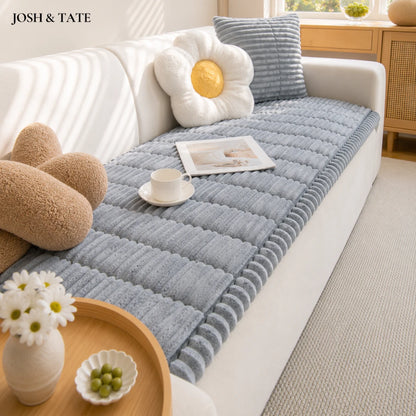 Josh & Tate - CozyLayer™ Plush Sofa Protector - Gray textured sofa cover on a white sofa with decorative pillows and a small table.