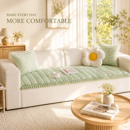 Josh & Tate - CozyLayer™ Plush Sofa Protector - White sofa with green cushions in a bright room with large windows.