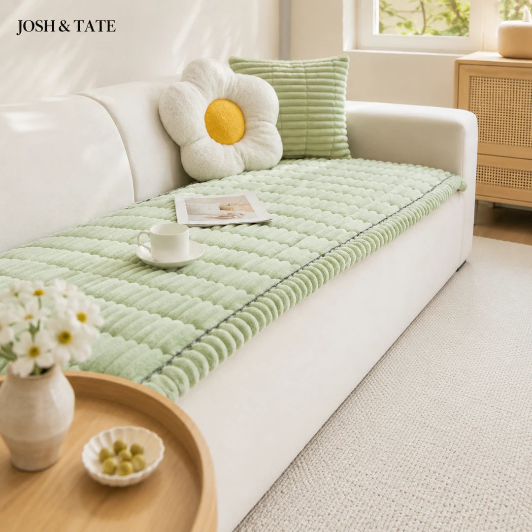 Josh & Tate - CozyLayer™ Plush Sofa Protector - Light green cushion on a white sofa with decorative pillows in a bright room.