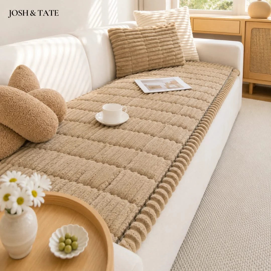 Josh & Tate - CozyLayer™ Plush Sofa Protector - Beige sofa cover on a white sofa with decorative pillows and a small table in a living room.