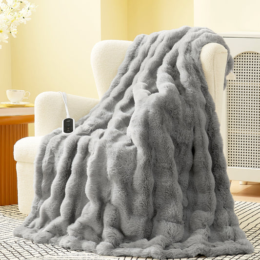 Gray fluffy blanket draped over a chair in a cozy living room setting.