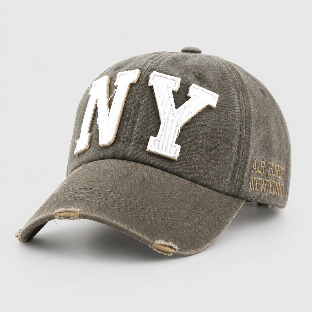 Josh & Tate - CraftWorn™ Distressed NY Cap - A distressed gray baseball cap featuring large white embroidered 'NY' letters on the front and gold embroidered 'AIR FORCE NEW YORK' text on the side, shown on a light gray background.