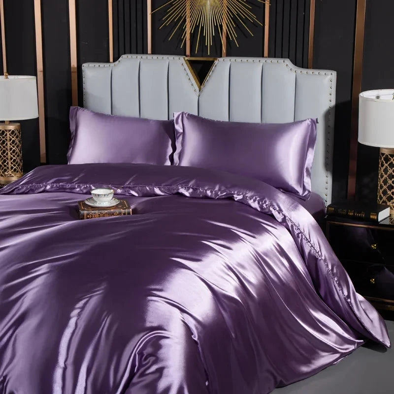 Josh & Tate - Josh & Tate - FloraStep™ Satin Fur-Lined Slipper - Purple satin bedding set on a bed with matching pillows and a decorative headboard.