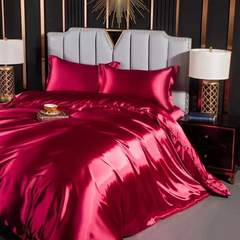 Josh & Tate - Josh & Tate - FloraStep™ Satin Fur-Lined Slipper - Bed with red satin bedding in a stylish bedroom setting.