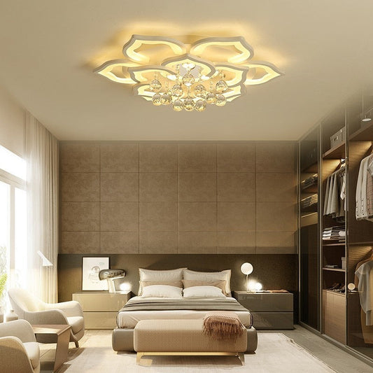 Modern bedroom with a decorative ceiling light fixture.