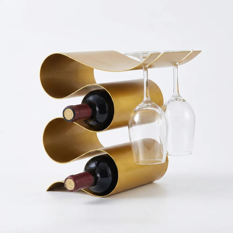 Gold wavy wine rack holding two bottles and two glasses on a white background