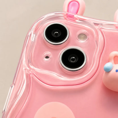Josh & Tate - CuteSilicone™ iPhone Case - A close-up of a pink phone case with a transparent camera cutout and small 3D cartoon bunny details on the corners.