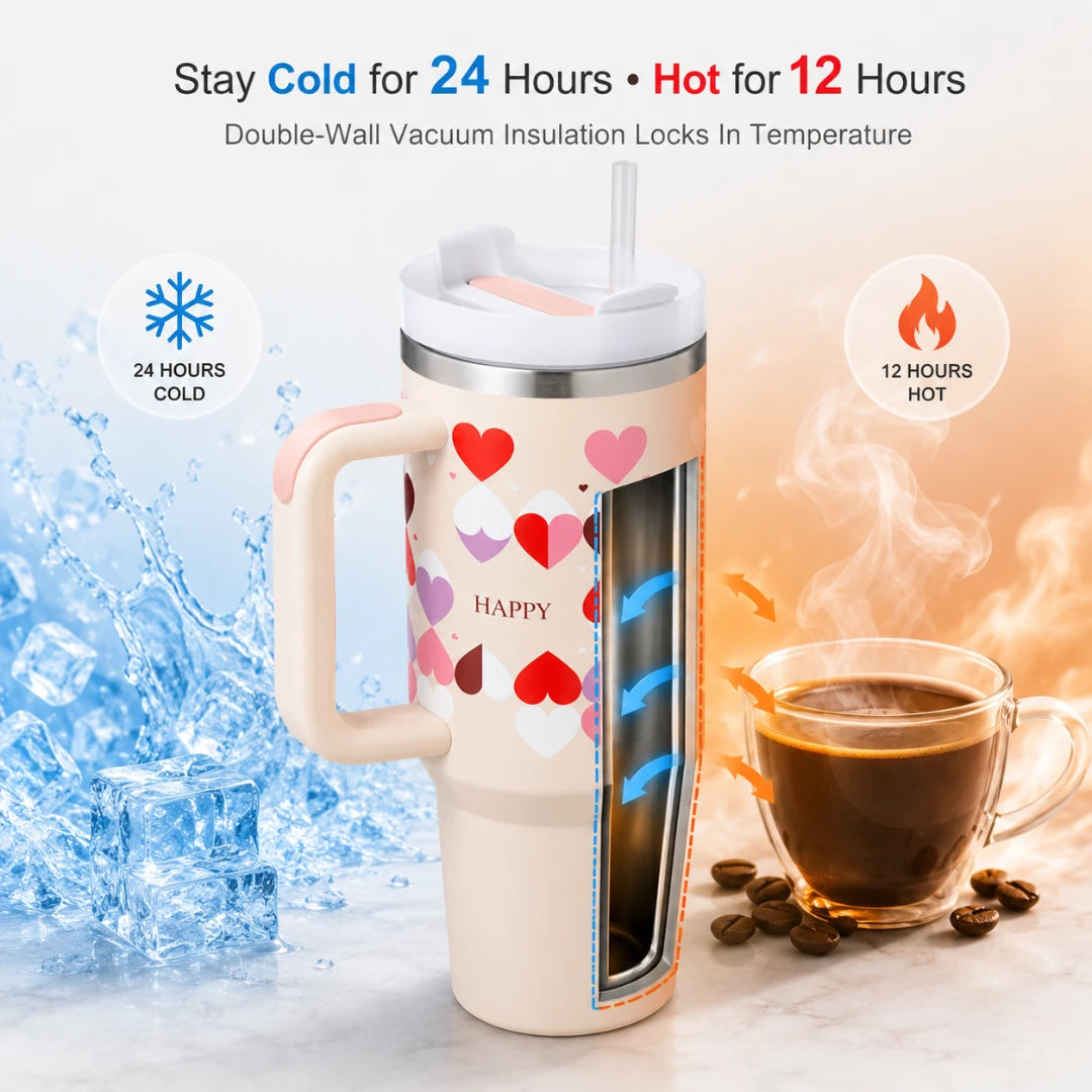 Josh & Tate - DayCarry™ 40oz Insulated Tumbler - A double-walled vacuum insulated travel tumbler with a handle, shown with a lid and straw. The tumbler body is cream with a pattern of red, pink, and purple hearts and the word HAPPY.