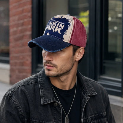 Josh & Tate - DistressedCap™ Embroidered Baseball Cap - A man wearing a distressed baseball cap with a navy blue brim, cream front panel, and maroon side panels. The cap features the text 'PINKIN PARK' and 'BOSTON, MASS.