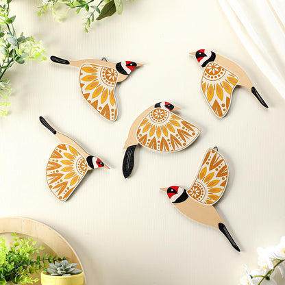 Decorative wall hooks shaped like birds with mandala designs on a light background.