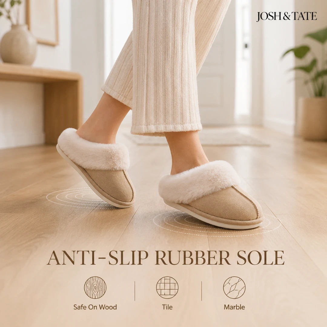 Josh & Tate - DriftWalk™ Plush Slippers - Person wearing beige slippers with white fur trim on a wooden floor, with 'Josh & Tate' branding.