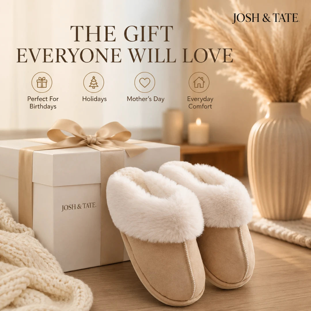 Josh & Tate - DriftWalk™ Plush Slippers - Beige slippers with a gift box and decorative elements on a wooden surface, featuring 'Josh & Tate' branding.