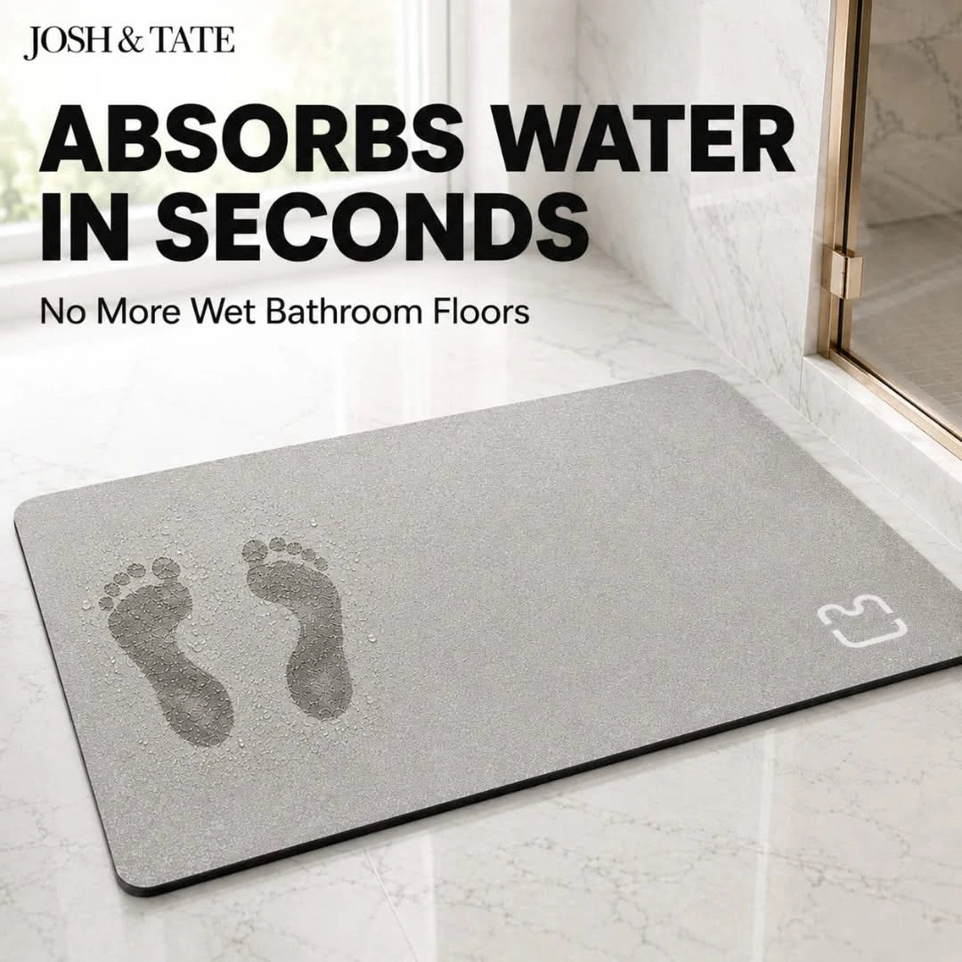 Josh & Tate - DryStep™ Diatomite Non-Slip Bath Mat - Gray mat with footprints on a bathroom floor, featuring text about water absorption.