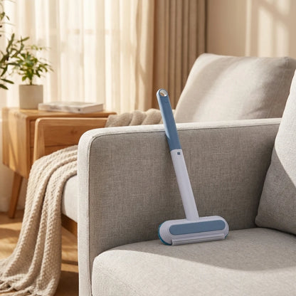 Josh & Tate - DualSwipe™ Multi-Surface Pet Hair Brush - Cleaning tool on a gray sofa in a living room setting