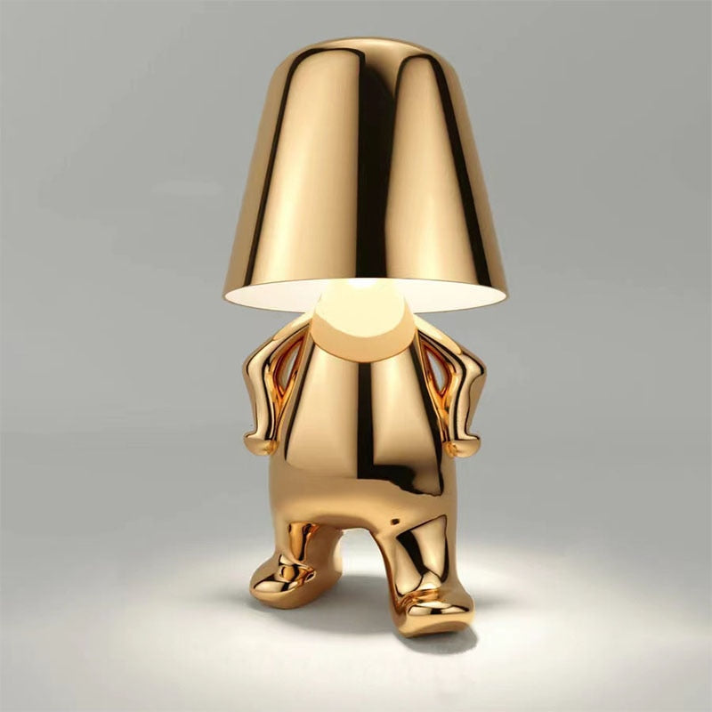 Gold-colored lamp with a unique design on a gray background