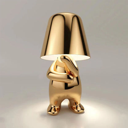 Gold-colored lamp with a unique design on a gray background