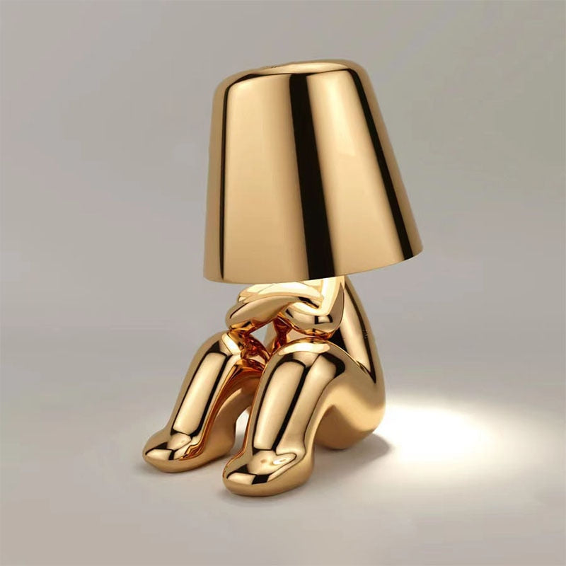 Gold lamp with a unique design on a gray background