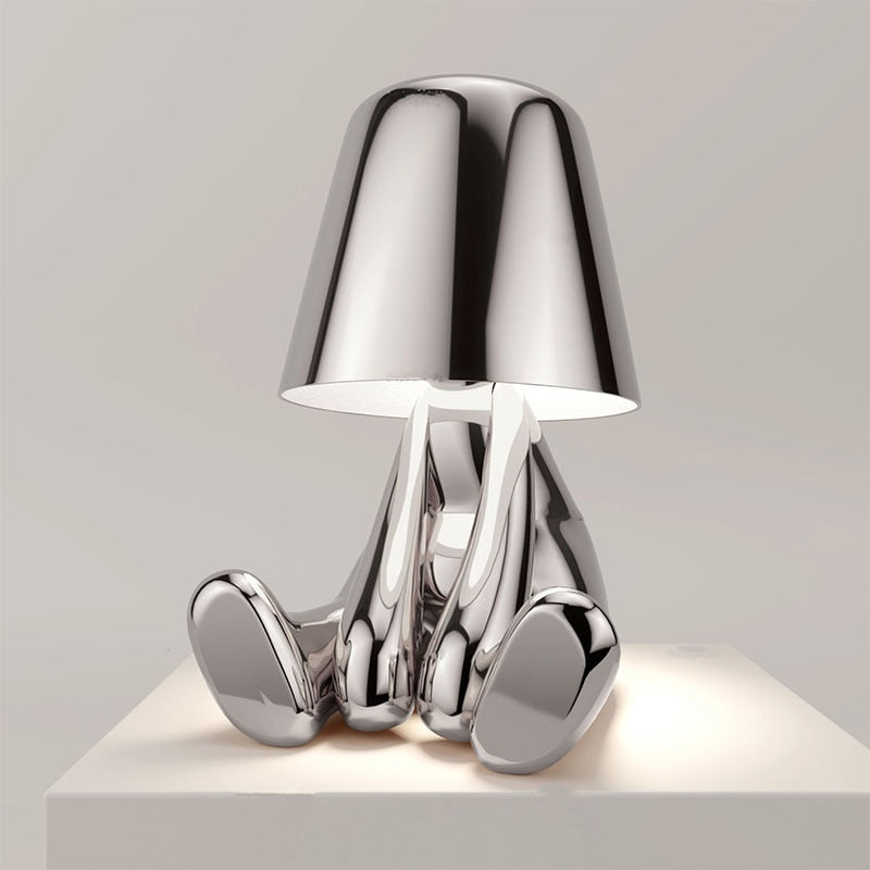 Chrome table lamp with a unique design on a light gray background