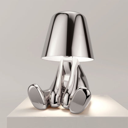 Chrome table lamp with a unique design on a light gray background