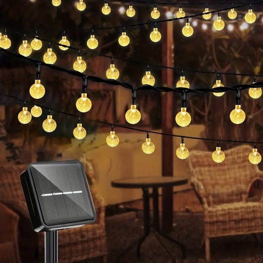 String of lights with a solar panel in an outdoor setting