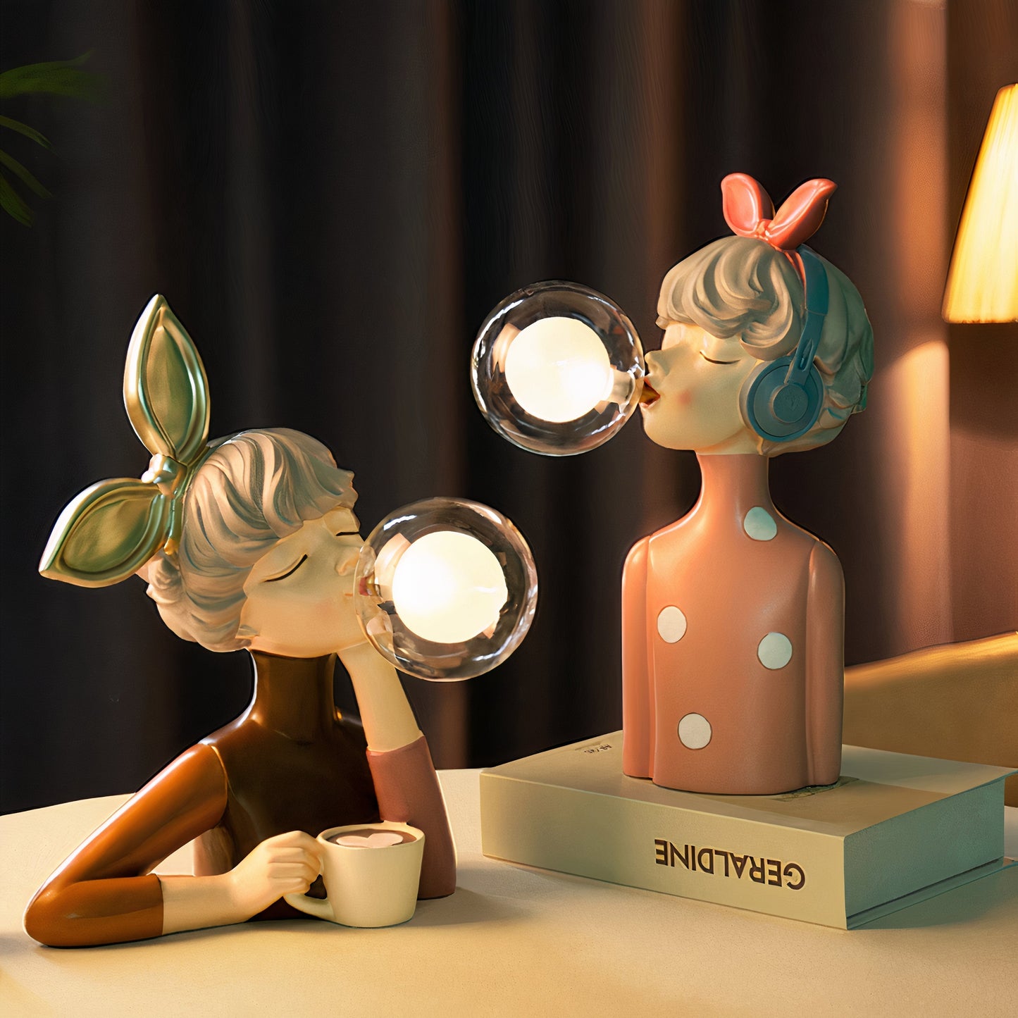 Two decorative lamps shaped like people with light bulbs for heads on a table.