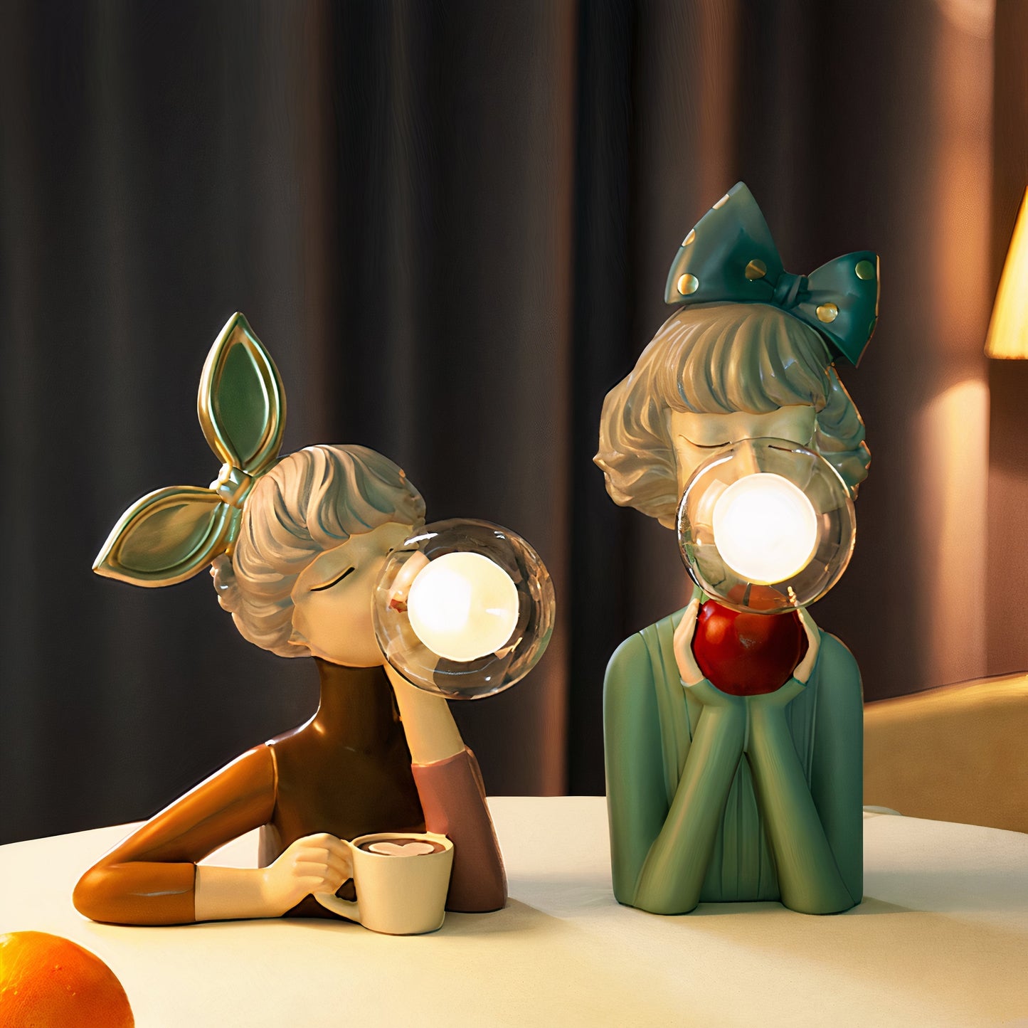 Two decorative figurines with light bulbs for heads on a table.