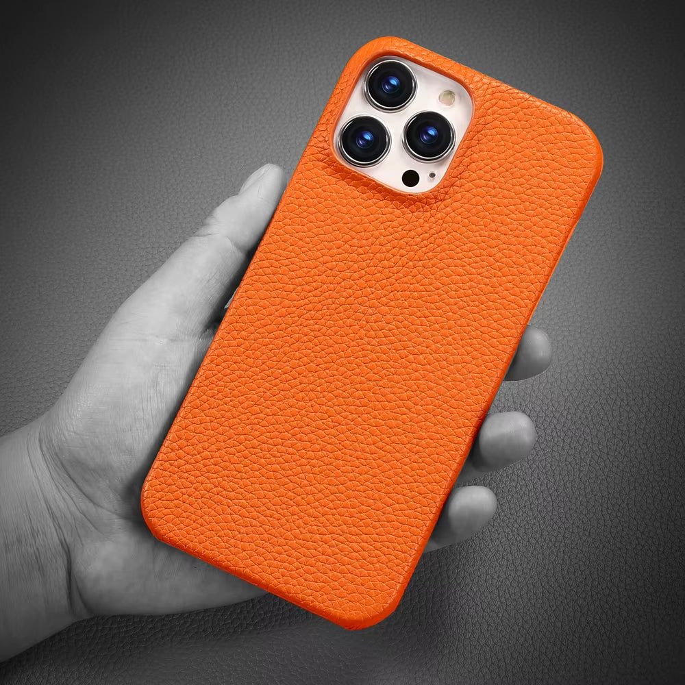 Orange phone case held in a hand against a dark background