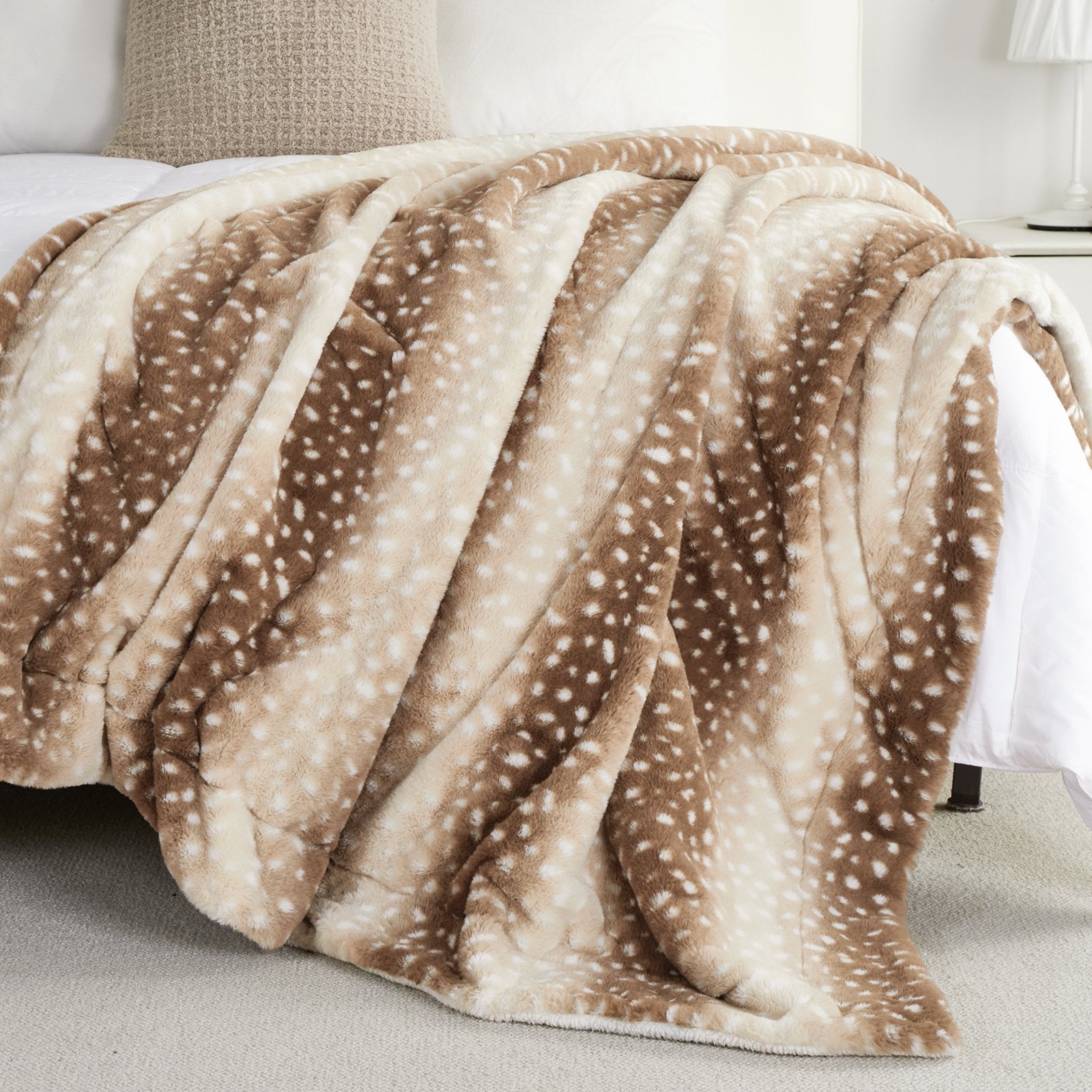 Brown and beige patterned blanket draped over a bed