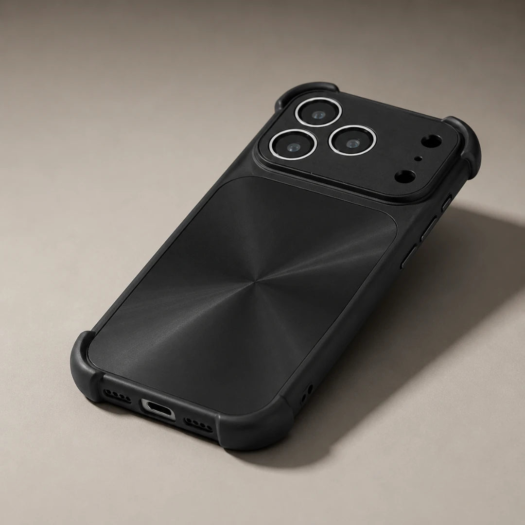 Josh & Tate - FlareShield™ iPhone Case - A matte black rugged phone case with a metallic brushed back panel and reinforced corners, shown on a light beige background.