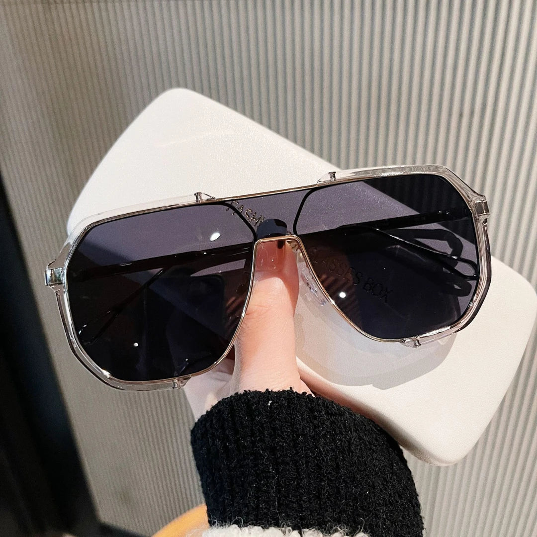 Josh & Tate - FlexFrame™ Bold Frame Glasses - Sunglasses held by a hand with a neutral background
