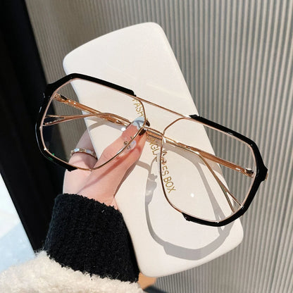 Josh & Tate - FlexFrame™ Bold Frame Glasses - Hand holding a pair of gold and black sunglasses with 'Glasses Box' branding.
