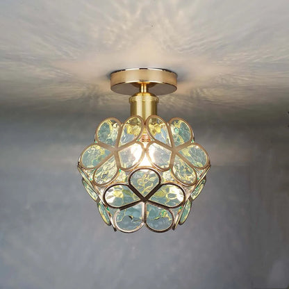 Ceiling light fixture with decorative glass shade on a neutral background
