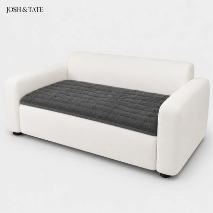 Josh & Tate - FluffLayer™ Plush Sofa Pad - White sofa with a gray quilted cushion on a white background, featuring the brand 'Josh & Tate'.