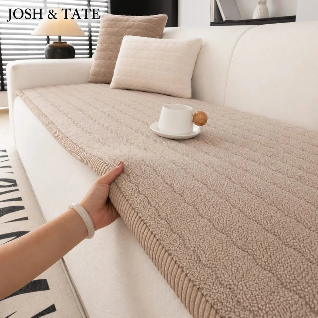Josh & Tate - FluffLayer™ Plush Sofa Pad - Beige textured throw blanket being draped over a white sofa with a cup and cookies on a small table.