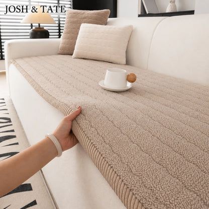 Josh & Tate - FluffLayer™ Plush Sofa Pad - Beige textured throw blanket being draped over a white sofa with a cup and cookies on a small table.