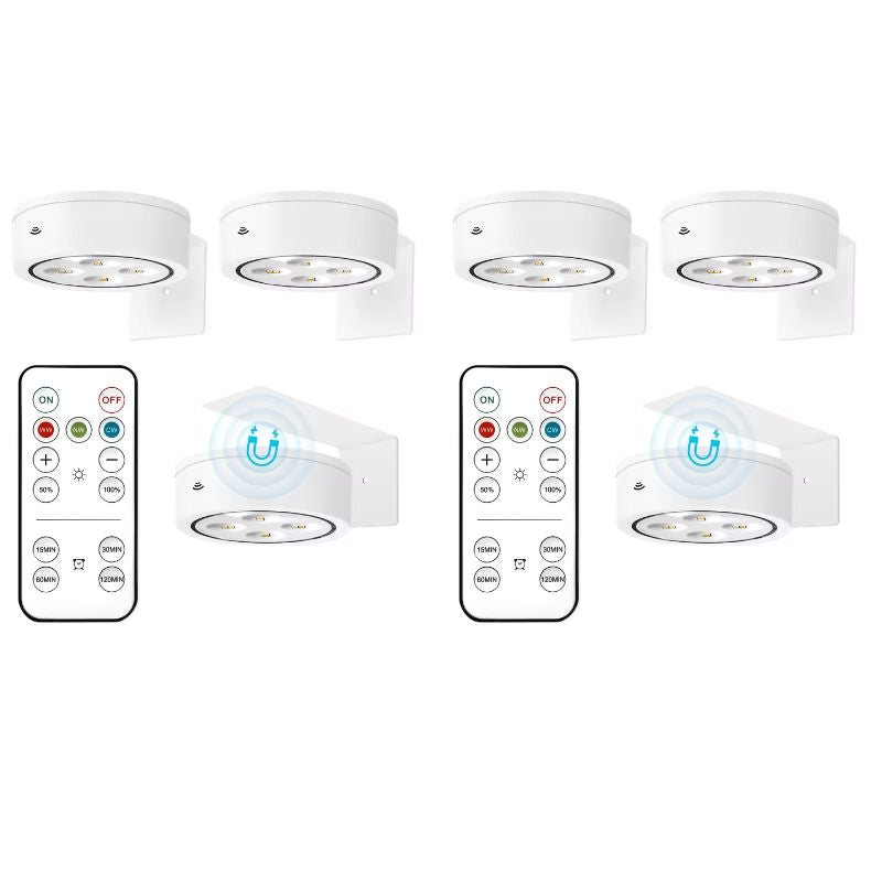Set of six white undercabinet lights with remote controls on a white background