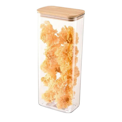 Clear storage container with wooden lid filled with orange snacks on a white background