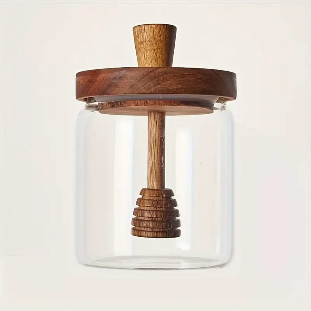 Glass jar with wooden lid and handle on a light background