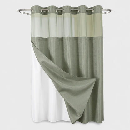 Josh & Tate - GlideCurtain™ No-Hook Shower Curtain - A two-tone shower curtain with a textured sage green upper section and a solid white lower section, hanging from a silver metal rod against a light gray background.
