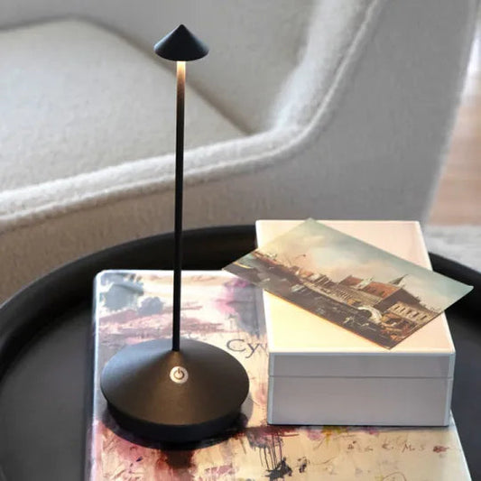 Black table lamp on a book with a blurred background